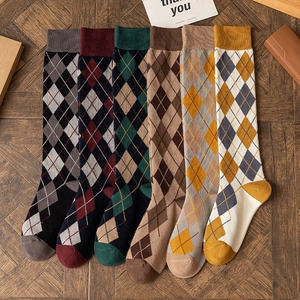 Japanese style argyle knee-high socks in six color options on vintage wood background