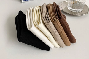 Detail of five pairs of ribbed cotton mid-calf socks in diverse earthy tones and textures