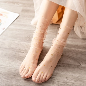 Detail of sheer tulle socks with sparkling gold star and moon sequins and wavy edges