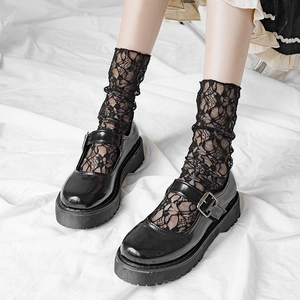 Black platform Mary Jane shoes with floral lace crew socks and metallic buckle strap