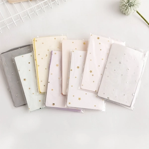 Detailed view of colorful mesh gift bags featuring gold foil stars and moon patterns