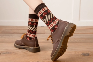Detail view of vintage thick wool socks with mushroom patterns and ribbed cuffs