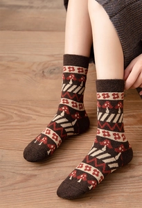 Close-up of thick wool socks with retro mushroom and flower knit patterns for winter