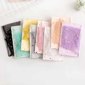 Detail of colorful sheer tulle socks with gold star and moon patterns on display cards