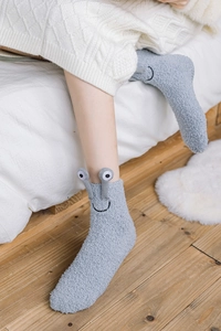 Detail of light grey coral fleece socks with 3D cartoon frog eyes and smiley embroidery