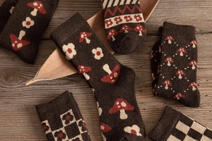 Detailed close-up of retro thick wool socks with mushroom and floral jacquard patterns