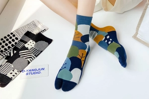 Detail of split toe Tabi socks featuring colorful tree and polka dot patterns