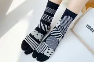 Detail of Tabi socks with black and white geometric patterns and houndstooth texture