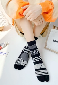 Detail of stylish black and white tabi socks with geometric patterns and split toe design
