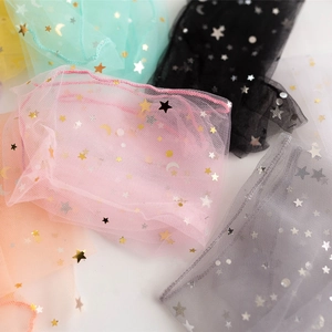 Flat lay of colorful sheer mesh socks with metallic gold star and moon patterns