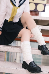 Detail of white knit leg warmers featuring satin bows for a sweet JK uniform style