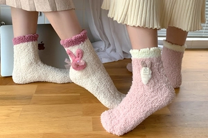 Detail of coral fleece socks featuring cute 3D bunny ears and sparkling bows