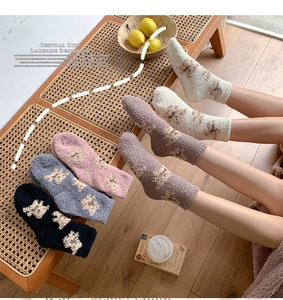 Close-up of thick coral fleece winter socks featuring a cute 3D bear pattern design