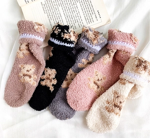 Detail of soft coral fleece winter socks with bear pattern and delicate lace trim set