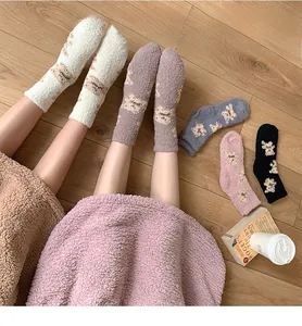 Detailed view of soft coral fleece winter socks with cute cartoon bear patterns