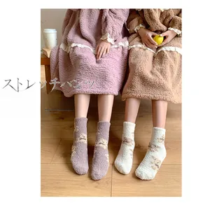 Close-up of cozy coral fleece socks with cute bear pattern for winter warmth