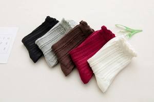 Detailed view of five pairs of cotton rib socks with elegant wavy lettuce edge cuffs