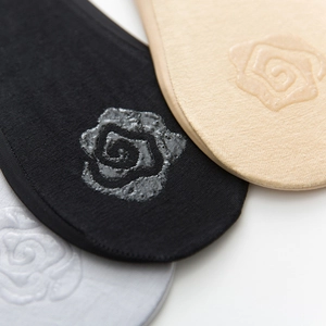 Close-up of rose-shaped silicone anti-slip heel pads on invisible low-cut socks