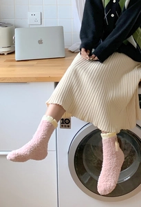 Cozy pink coral fleece socks with yellow ribbed cuffs and cute bow detail for winter