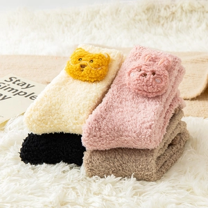 Detail showing thick coral fleece socks with cute 3D animal patterns for winter warmth