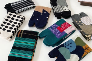 Close-up of Japanese Tabi socks set with geometric and floral patterns on white background