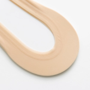 Macro detail of seamless skin-tone invisible socks with smooth high-elastic fabric edges