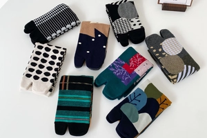Close-up of various patterned cotton Tabi socks with dots and stripes on white background