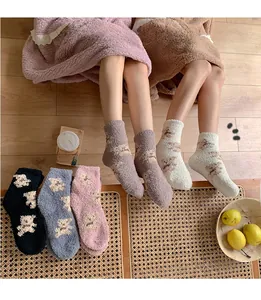 Close-up of thick coral fleece socks with cute 3D bear pattern in five pastel colors