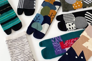 Detailed flat lay of colorful cotton tabi socks with various geometric and floral patterns