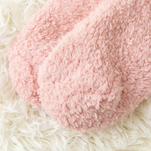 Close-up of soft pink coral fleece winter socks showing thick plush texture and warmth