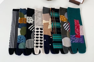 Detailed close-up of cotton Tabi socks with diverse artistic patterns and split-toe design