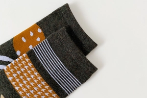Close-up of knit fabric texture with stripes and patterns on split-toe cotton socks