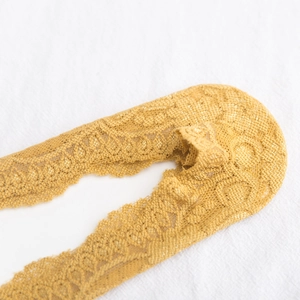 Close-up of floral lace boat socks in mustard yellow with non-slip silicone edge