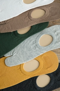 Detail of multi-color cotton Tabi socks on wood background showing two-toe design