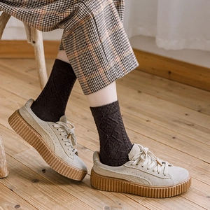 Minimalist beige wool sneakers with thick gum soles and vintage argyle socks styling