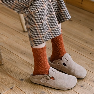 Winter wool socks in burnt orange with diamond pattern paired with beige suede mules