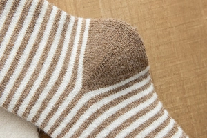 Détail de la texture tricotée et des coutures sur les chaussettes d'hiver rayées