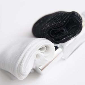 Close-up of black and white mesh socks with silver glitter yarn and ruffles