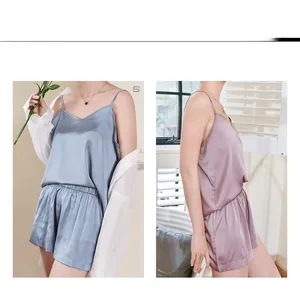 Detail of V-neck satin camisole set showing smooth silk texture and soft pastel colors