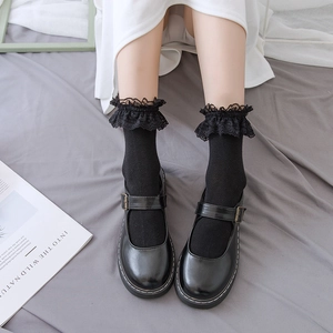 Detail of black Mary Jane shoes with mesh lace socks in vintage Lolita style