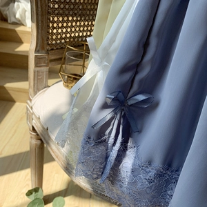 Close-up of lace hem and satin bow details on thin ice silk safety pants for women