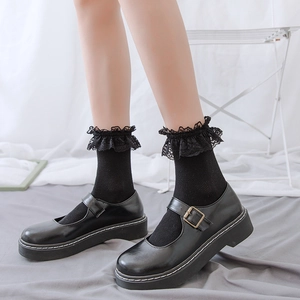 Japanese lolita style mesh socks with black lace trim paired with platform Mary Jane shoes