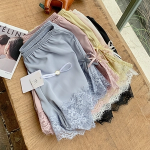 Flat lay of multiple ice silk safety shorts with delicate eyelash lace and bows