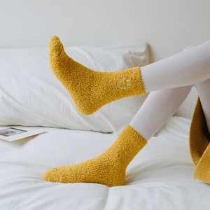 Thick ginger coral fleece socks with white smiley face embroidery for winter warmth