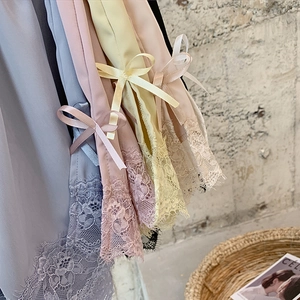 Detailed close-up of lace edges and satin bows on colorful ice silk safety shorts
