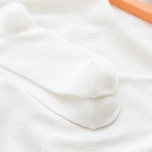 Close-up of flat seamless toe stitching on white Lolita lace mesh cotton socks