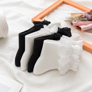 Detail of delicate double-layer lace ruffles on sweet Lolita style mid-calf socks
