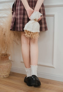 Detail of white ruffle-edge mid-calf socks with double bows for JK school uniform style