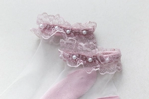 Détail de chaussettes en résille blanche avec dentelle rose et perles de style doux