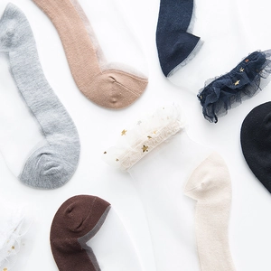 Detail of sheer mesh crew socks with star pattern and elegant ruffle cuffs in various colors